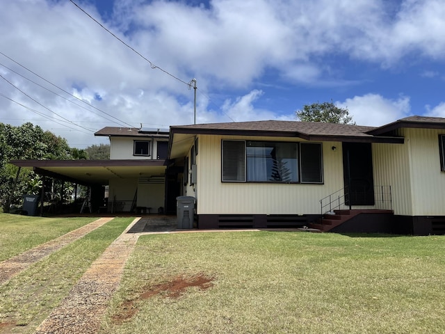 4013 Hoohana St, Lihue, HI 96766 - view of front facade featuring a front yard, entry steps, driveway, roof mounted solar panels, and an attached carport