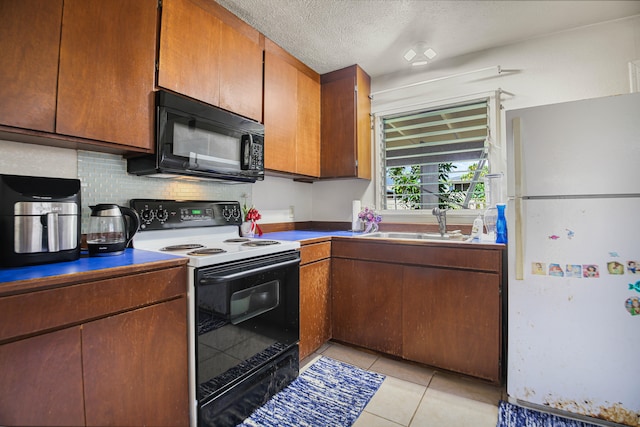 4013 Hoohana St, Lihue, HI 96766 - kitchen featuring electric range, freestanding refrigerator, black microwave, a sink, and light tile patterned flooring