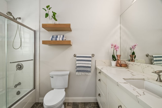 5413 Nakoa St, Koloa, HI 96756 - bathroom featuring vanity, toilet, baseboards, shower / bath combination with glass door, and wood finished floors