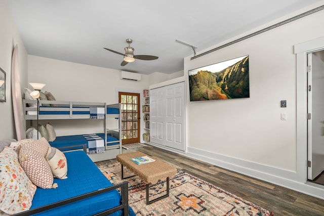 5413 Nakoa St, Koloa, HI 96756 - bedroom with a wall unit AC, wood finished floors, baseboards, a closet, and ceiling fan