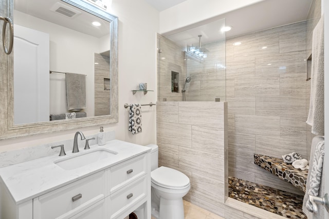 bathroom with toilet, walk in shower, vanity, tile patterned flooring, and recessed lighting