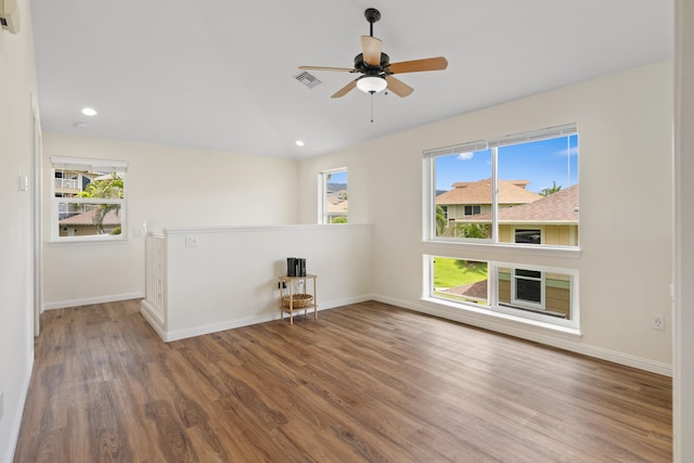 empty room featuring wood finished floors, ceiling fan, baseboards, recessed lighting, and lofted ceiling
