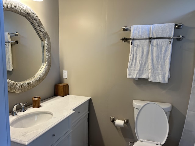 bathroom with toilet and vanity