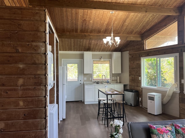 kitchen featuring white cabinets, light countertops, dark wood-style flooring, an inviting chandelier, and wooden ceiling