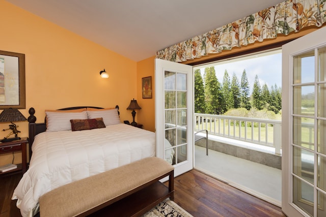 bedroom featuring multiple windows, vaulted ceiling, dark wood-style floors, and access to outside