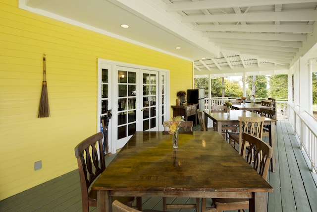 wooden deck with french doors and outdoor dining area