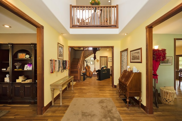 entrance foyer featuring recessed lighting, baseboards, wood finished floors, and stairway