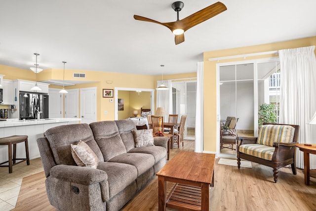 4771 Pepelani Lp Unit 411, Princeville, HI 96722 - living room with light wood-style flooring, visible vents, and ceiling fan