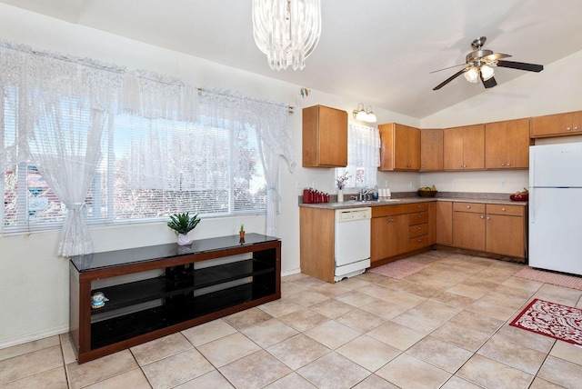 kitchen with brown cabinets, white appliances, plenty of natural light, and ceiling fan with notable chandelier