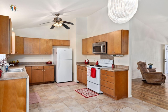 kitchen with brown cabinetry, white appliances, high vaulted ceiling, and a sink