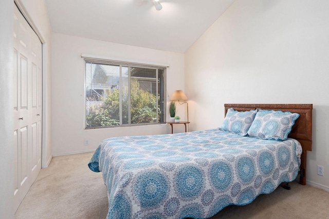 bedroom with baseboards, lofted ceiling, and carpet floors