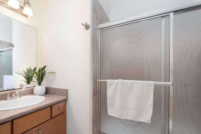 full bath with a shower stall and vanity