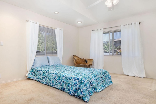 bedroom with vaulted ceiling, carpet, baseboards, and a ceiling fan