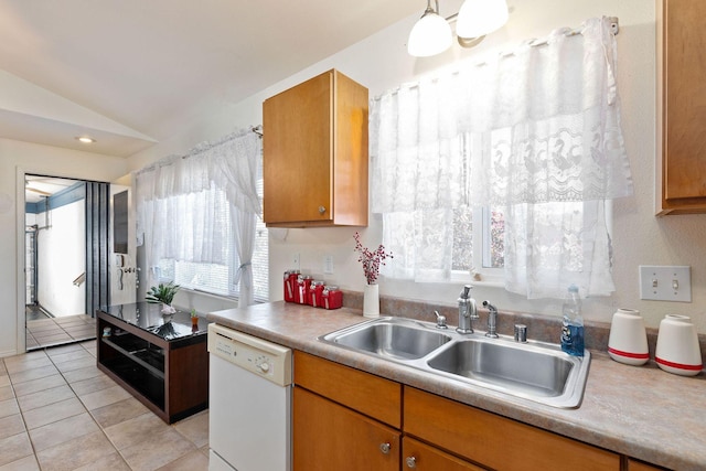 kitchen featuring dishwasher, light tile patterned flooring, a sink, vaulted ceiling, and light countertops