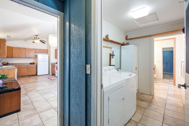 laundry room featuring light tile patterned floors, a sink, laundry area, ceiling fan, and independent washer and dryer