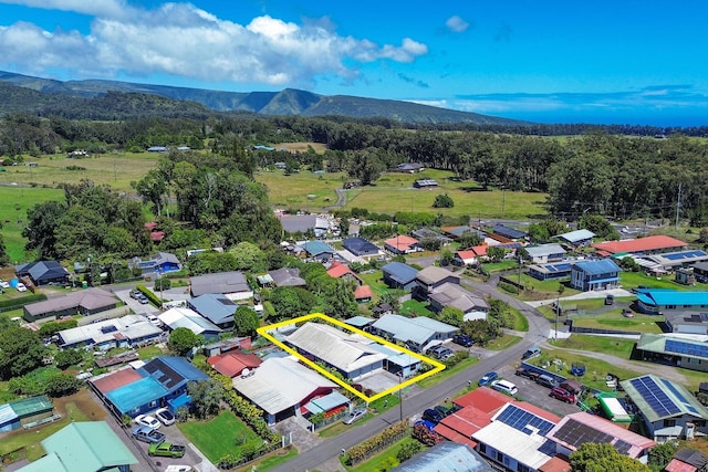 aerial view with a mountain view, a residential view, and a view of trees