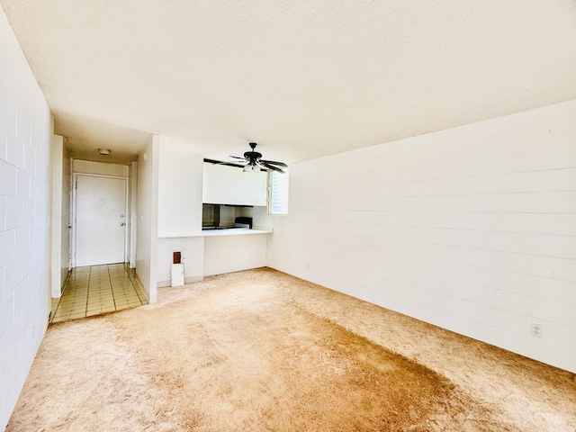 unfurnished living room featuring carpet and ceiling fan