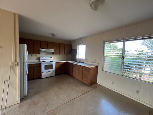 9622 Waena Rd, Waimea, HI 96796 - kitchen with a sink, under cabinet range hood, white appliances, brown cabinetry, and light countertops