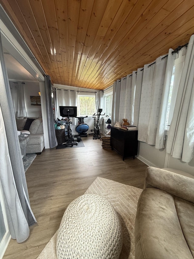 living area featuring wood ceiling and wood finished floors