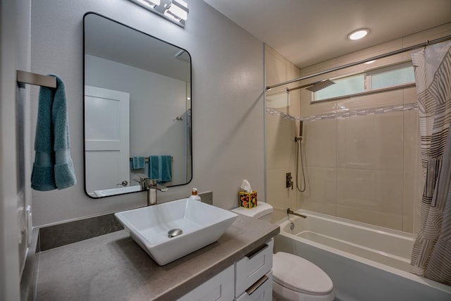 full bath featuring toilet, shower / bath combo, and vanity
