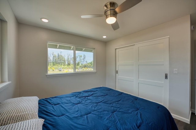 bedroom with recessed lighting, a closet, ceiling fan, dark wood-style flooring, and baseboards