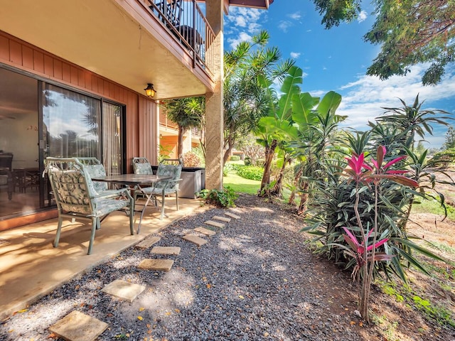 view of patio / terrace with a balcony and outdoor dining area