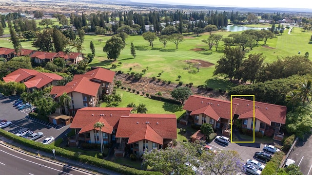 birds eye view of property with a water view and golf course view