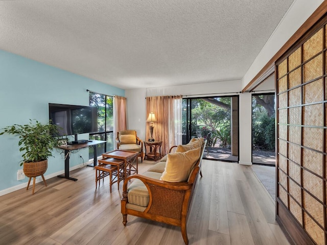 sitting room with wood finished floors and a textured ceiling