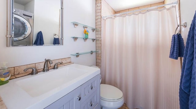 full bathroom featuring washer / clothes dryer, toilet, vanity, and a shower with curtain