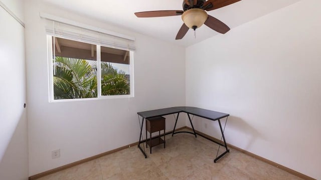 unfurnished office with baseboards and a ceiling fan