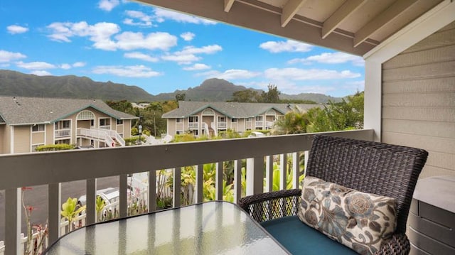 balcony featuring a mountain view, a residential view, and outdoor dining space