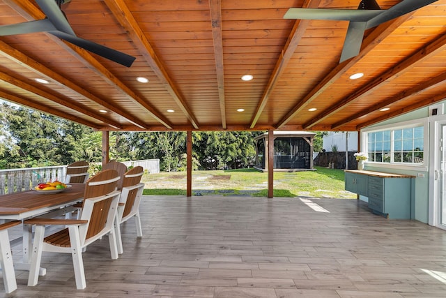 wooden deck featuring a lawn, a fenced backyard, and outdoor dining space