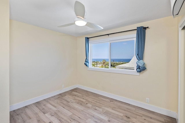 unfurnished room with baseboards, a ceiling fan, and wood finished floors