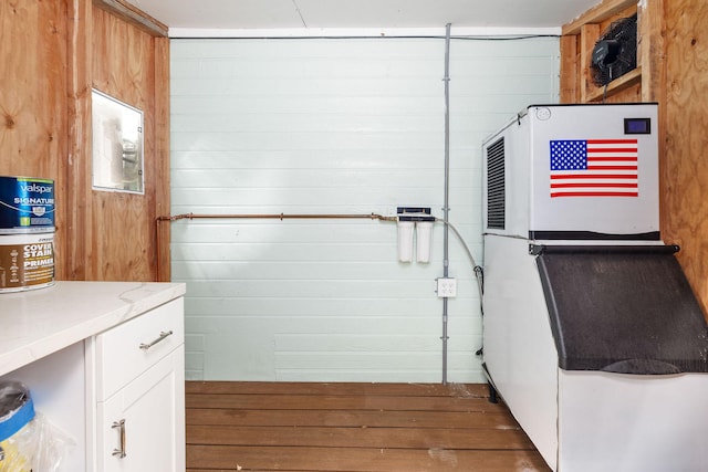 clothes washing area featuring wood finished floors