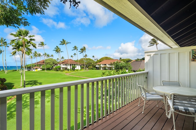 wooden deck featuring a residential view, a lawn, and a water view
