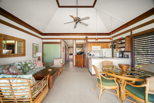 living area with high vaulted ceiling, ceiling fan, healthy amount of natural light, and light carpet