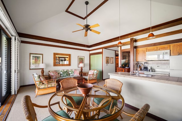 dining area featuring ceiling fan, baseboards, plenty of natural light, and high vaulted ceiling