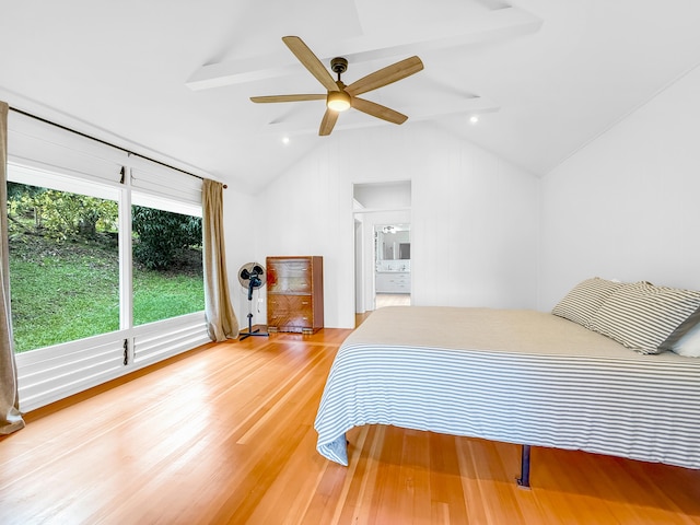 bedroom featuring light wood-style flooring, vaulted ceiling, a ceiling fan, and ensuite bathroom