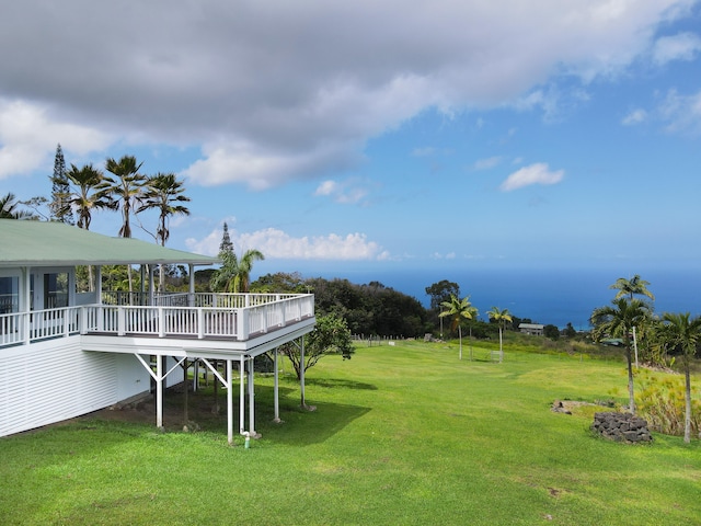 view of green lawn with a wooden deck