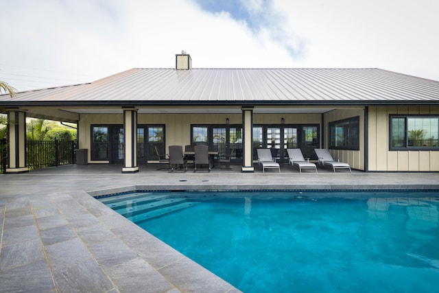 pool featuring a patio, french doors, and fence