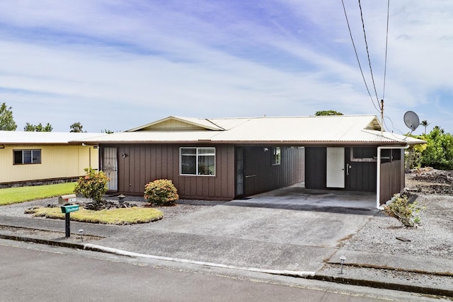 ranch-style house with a carport and driveway