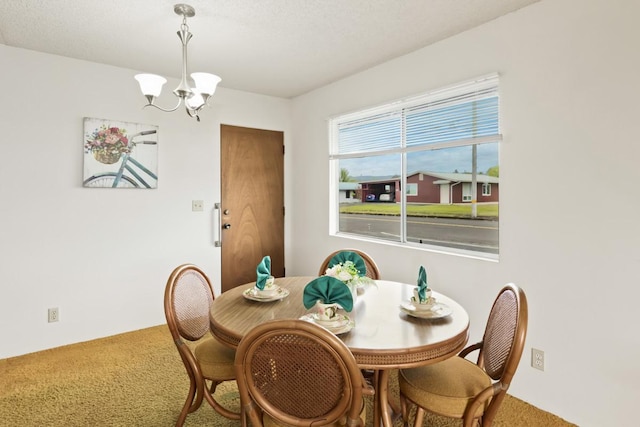 carpeted dining space with a chandelier