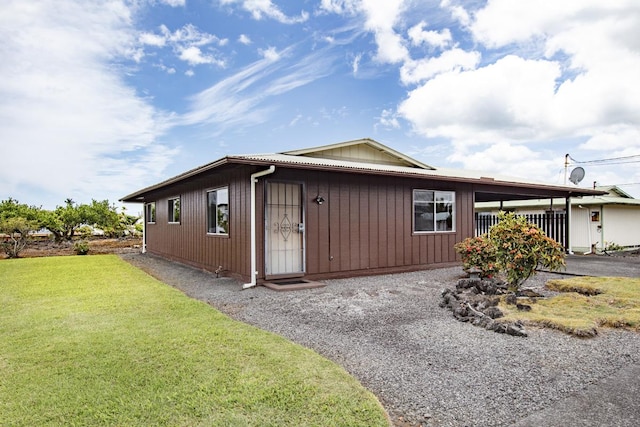 view of side of property featuring a yard