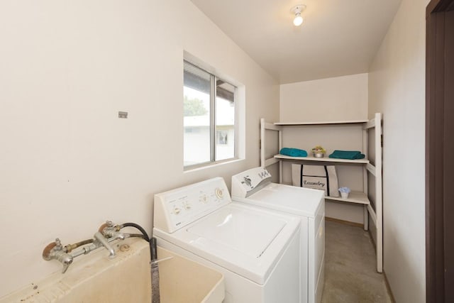 clothes washing area featuring washer and clothes dryer and light carpet