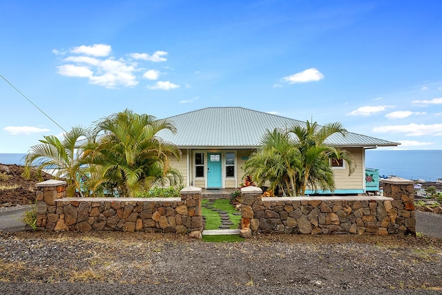 view of front of home featuring a water view and metal roof