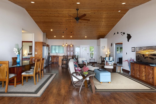 living room with ceiling fan with notable chandelier, dark wood-style floors, wooden ceiling, and high vaulted ceiling