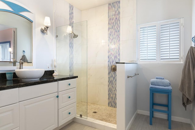 bathroom featuring a walk in shower and vanity