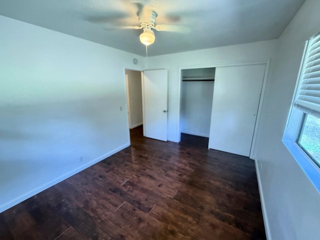 unfurnished bedroom with baseboards, a closet, ceiling fan, and wood finished floors