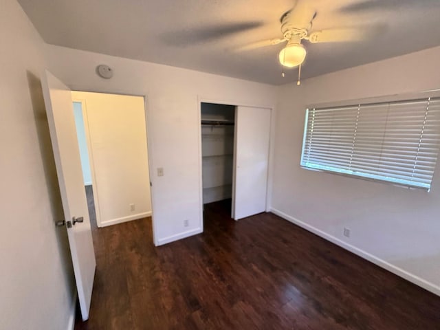 unfurnished bedroom with a closet, wood finished floors, baseboards, and a ceiling fan