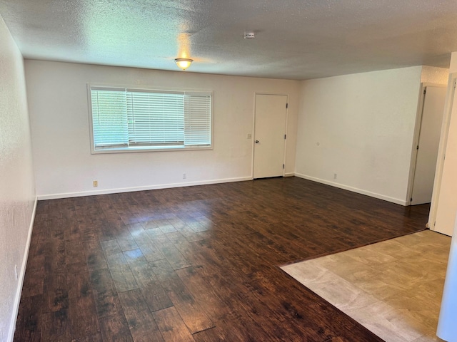 unfurnished room with baseboards and hardwood / wood-style flooring